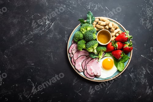 Healthy Plate with Ham, Broccoli, Strawberries and Egg
