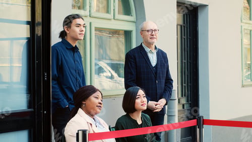 Preview: Diverse people waiting outside store