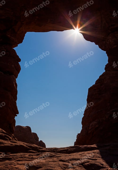 Preview: Dramatic view of the sunburst shining through a natural rock arch, Arches National Park