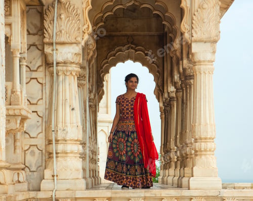 Preview: Indian woman standing between arches and Pillars.