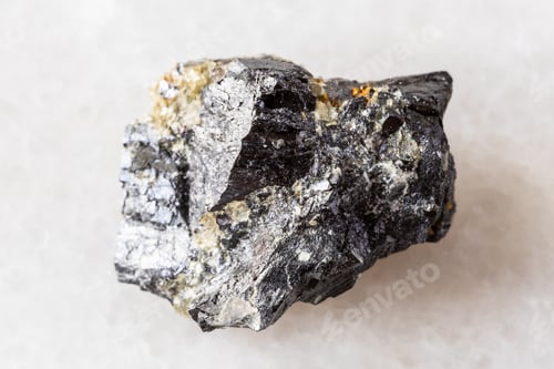 Preview: sample of rough wolframite mineral on white marble