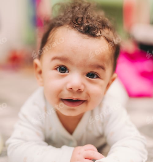 Preview: Portrait of cute happy smiling mixed race toddler boy in white outfit at home in living room