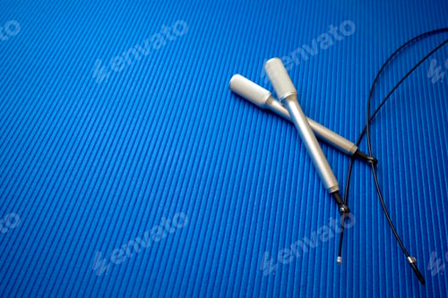 Preview: Jumping rope on blue mat background in a gym