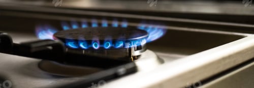 Preview: Close-up of a blue fire from a kitchen stove. two gas burners with a burning flame. wide baner