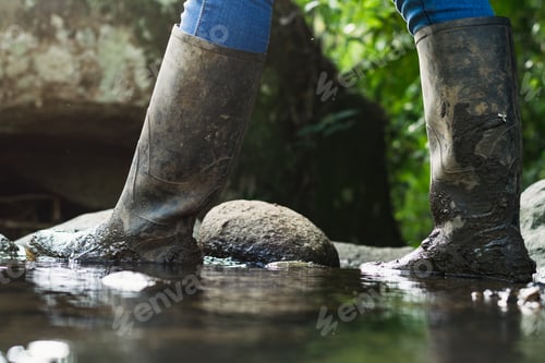 Preview: detailed view of a peasant girl's marsh boots crossing a stream, putting her shoes