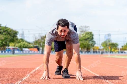 Preview: Caucasian young man athlete running exercise on a track at the stadium.