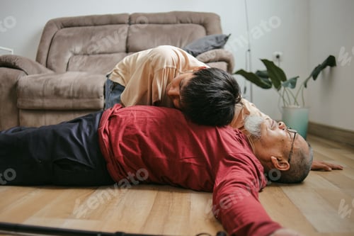 Preview: Young Man Checking Vital Parameters Of An Unconscious Elderly After Heart Attack