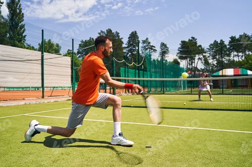 Preview: Focused athlete playing a singles match with his tennis partner