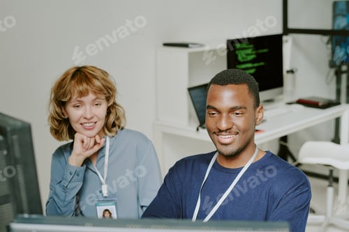 Preview: Cheerful Young Colleagues At Work In Office