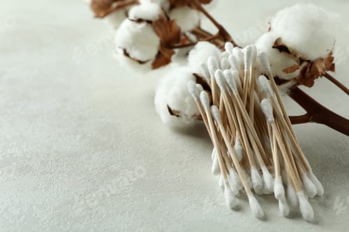 Preview: Cotton branch and cotton swabs on white textured background