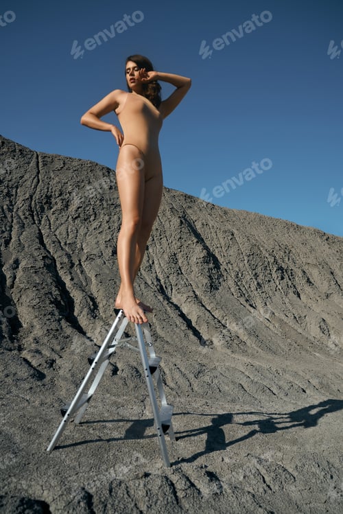 Preview: Woman wearing swimsuit posing on ladder in quarry