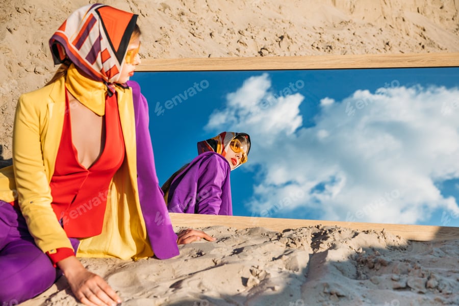 Cover for fashionable model looking at her reflection in mirror