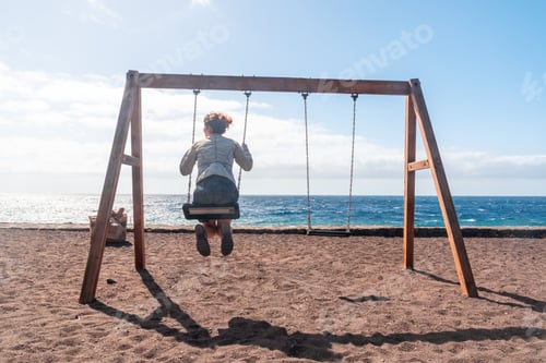 Preview: A woman swinging on a swing on the beach of the island of El Hierro. Canary Islands