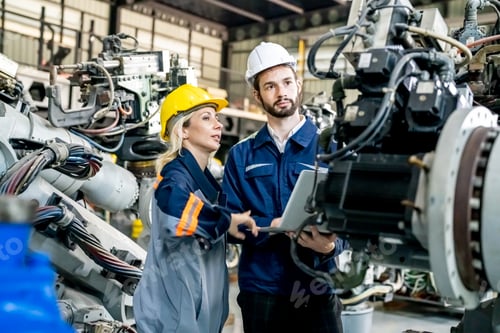 Preview: Engineer with robot in automotive parts factory