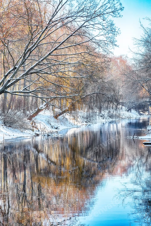 Preview: Breathtaking landscape in city park with snowy trees and beautiful frozen river.