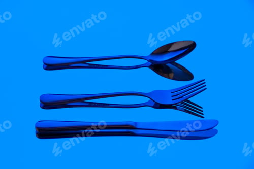 Preview: front view different cutlery spoon knife and fork on blue background table kitchen food photo color