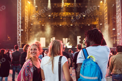Preview: Friends watching music concert outdoors