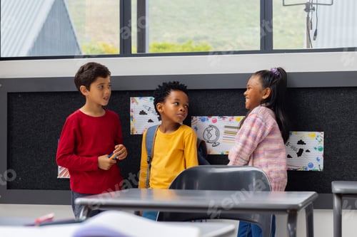 Preview: Biracial boy converses with an African American boy and biracial girl in a school classroom