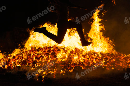 Preview: Summer solstice celebration jumping into the fire. Burning flames