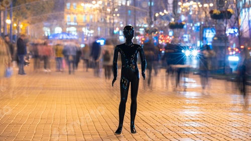 Preview: The mannequin standing on the crowd street. evening time