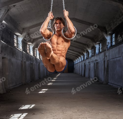 Preview: Man workouts in the air with gimnastic rings.