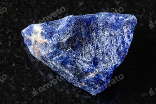 Preview: sample of raw sodalite rock on black granite