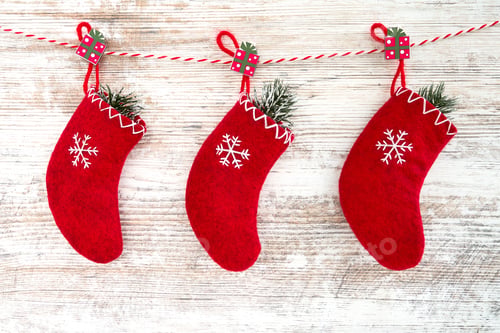 Preview: Festive Red Christmas Stockings Hanging on Wooden Background