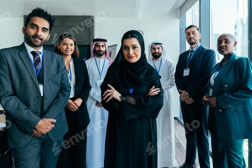 Preview: Diverse international business team standing in dubai office meeting