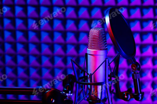 Preview: Professional studio microphone against acoustic foam panel background in neon light
