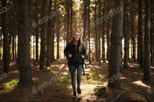 Preview: What will I find today. Portrait of a happy young woman exploring a forest on her own.