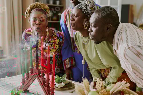 Preview: Group of Black Adults Blowing out Kinara Candles during Kwanzaa Ceremony