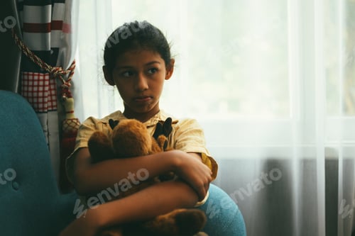 Preview: Upset girl hugging knees alone, Concept of lonely girl and kid with trouble