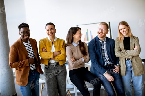 Preview: Group of positive businesspeople standing together in the office