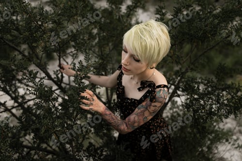 Preview: woman with a tattoo on her arm and short green hair