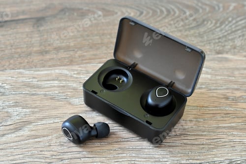 Preview: Generic Black wireless earbuds in a charging case on a wood background. (logos and labels removed)