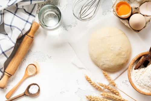 Preview: Dough and ingredients for the preparation of pasta, dough, eggs, flour, water and salt on a light ru