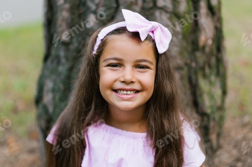 Preview: Portrait of a Cute Little Girl with a Wide and Beautiful Smile in a Pink Dress