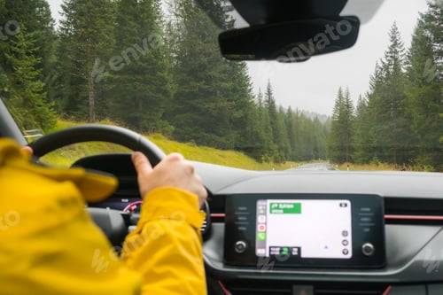 Preview: Traveler drives car through pass among mountain forest