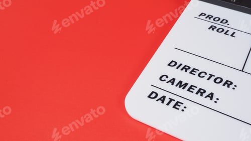 Preview: Clapperboard or movie slate on red background.it use in video production and film industry .