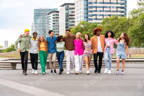 Preview: Happy playful multiethnic group of young friends bonding outdoors