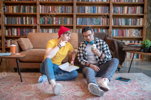 Preview: Dark-haired man in eyeglasses discussing new pills with his friend