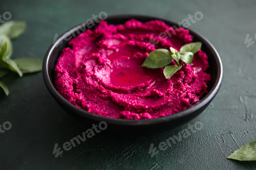 Preview: Humus Bowl. Red beetroot hummus with fresh vegetables, olive oil on table