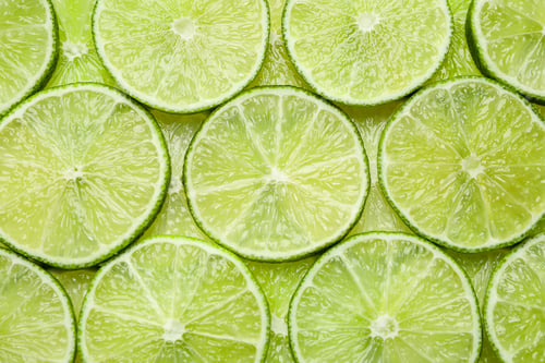Preview: Many fresh juicy lime slices as background, top view