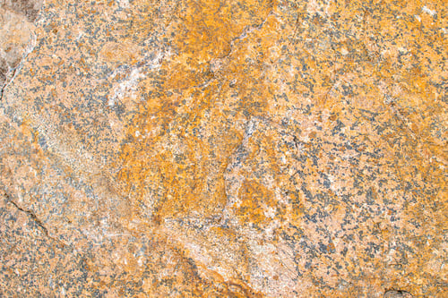 Preview: Raw rough yellow golden brown granite texture background. Natural rock stone texture background