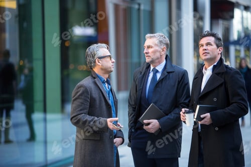 Preview: Businessmen talking in street