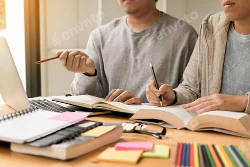 Preview: Teenager studying at desk and doing homeworks and using laptop.