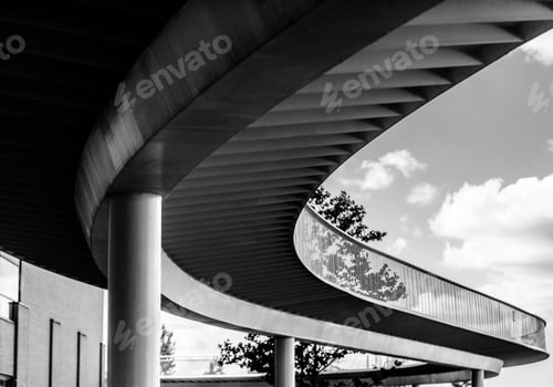 Preview: Grayscale shot of a bridge near buildings