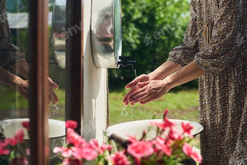 Preview: Woman Washing Hands Outdoors near Sink on Sunny Summer Day