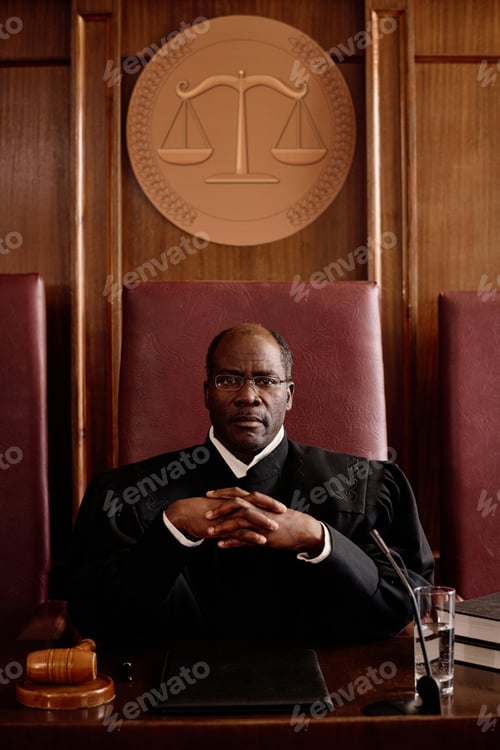 Preview: Serious mature African American male judge in black mantle looking at camera