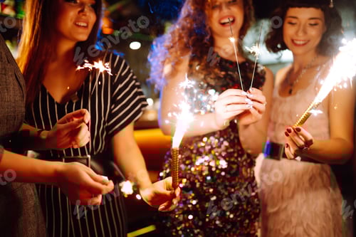 Preview: Three young Woman with champagne glasses at night club. Women friends drinking champagne in the bar.